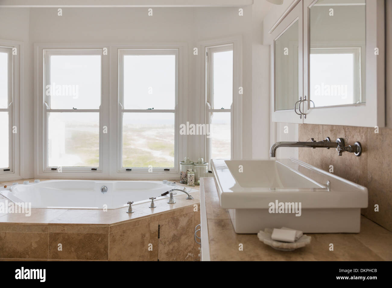 Sink And Jacuzzi Tub In Luxury Master Bathroom Stock Photo