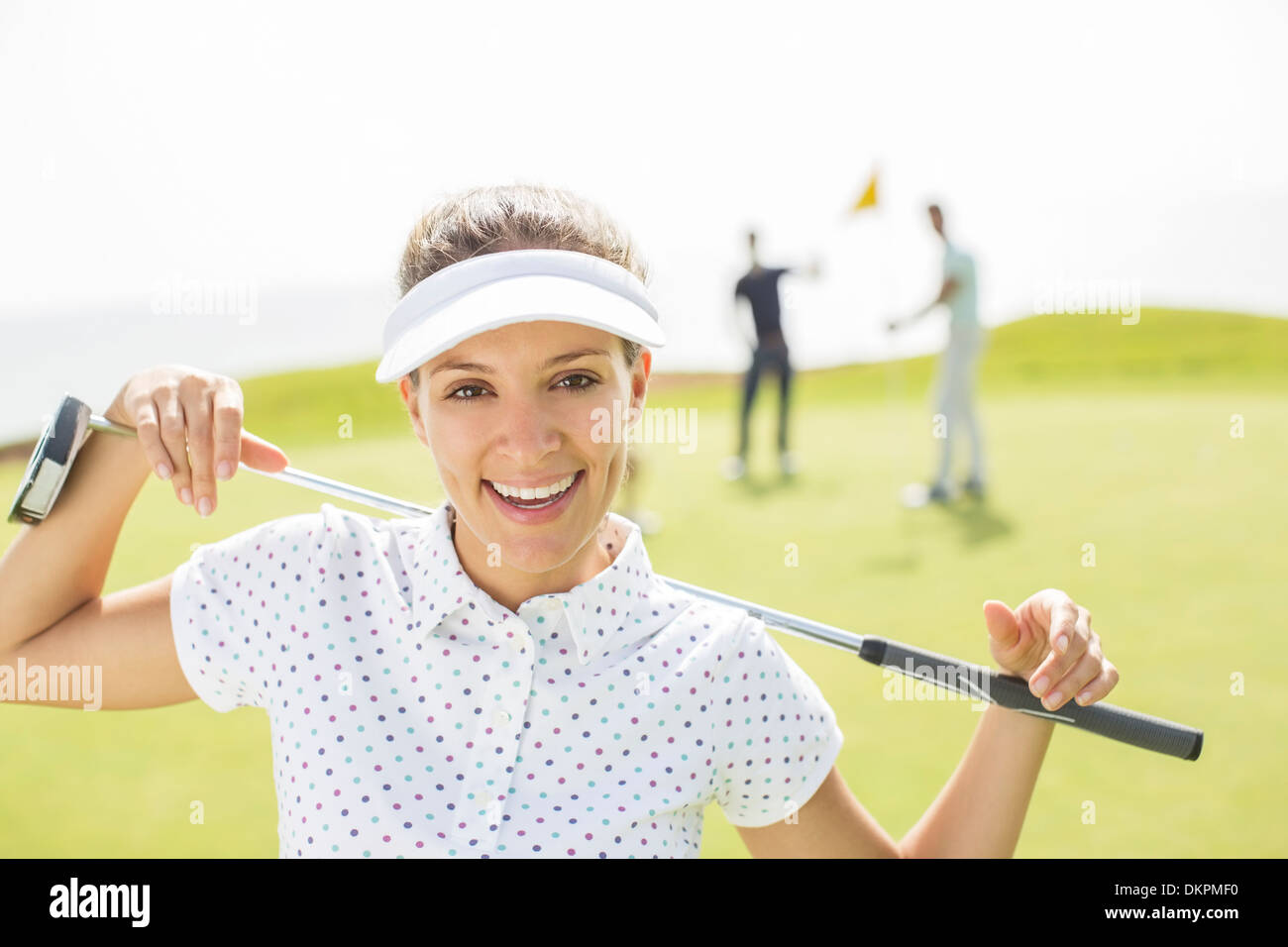 Woman holding golf club Stock Photo Alamy