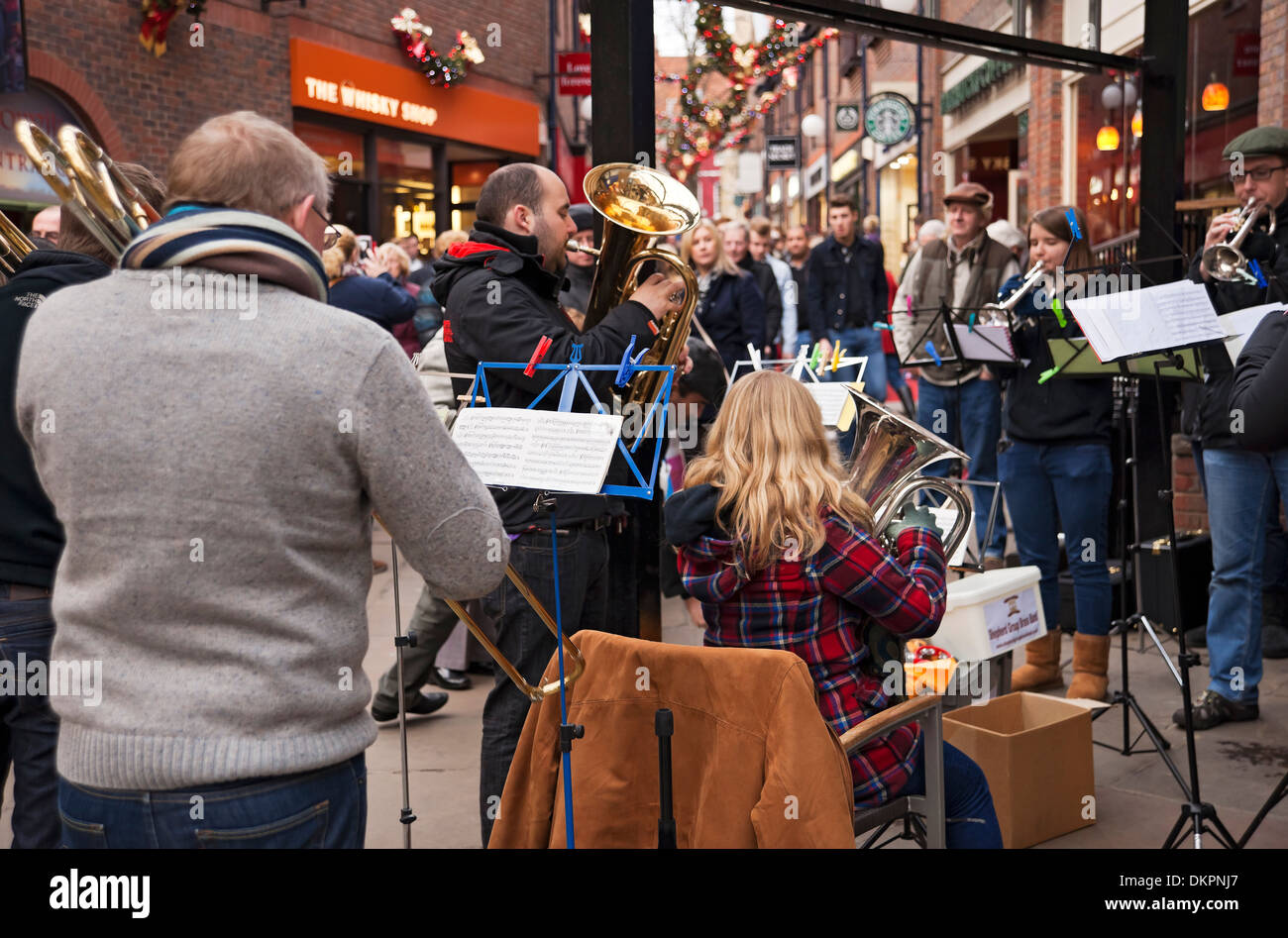 Members people musicians of brass band playing Christmas carols Coppergate York North Yorkshire England UK United Kingdom GB Great Britain Stock Photo