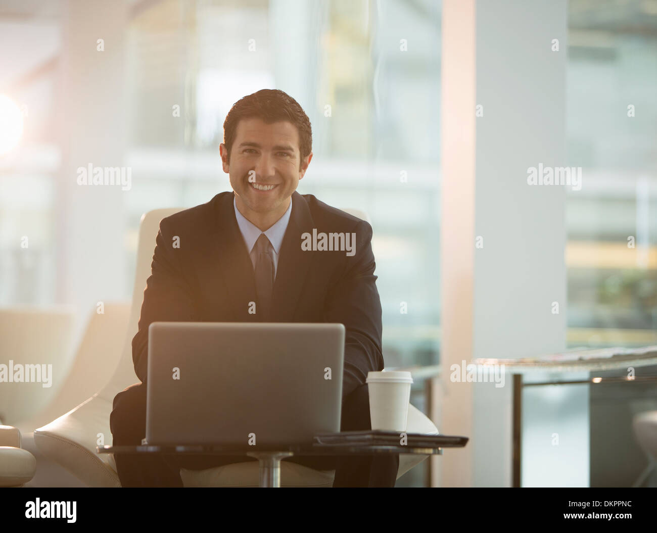 Businessman using laptop in office Stock Photo