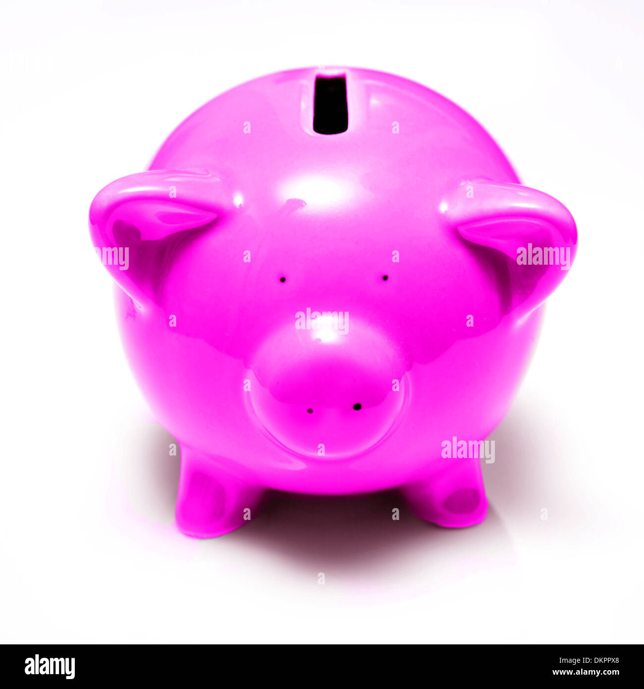 Purple piggy bank money box isolated on a white studio background Stock