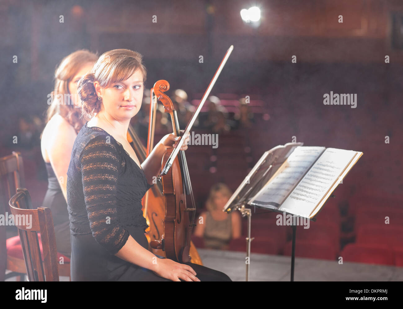 Violinists preparing for performance on theater stage Stock Photo