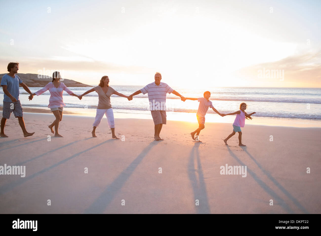 Family holding hands on beach Stock Photo