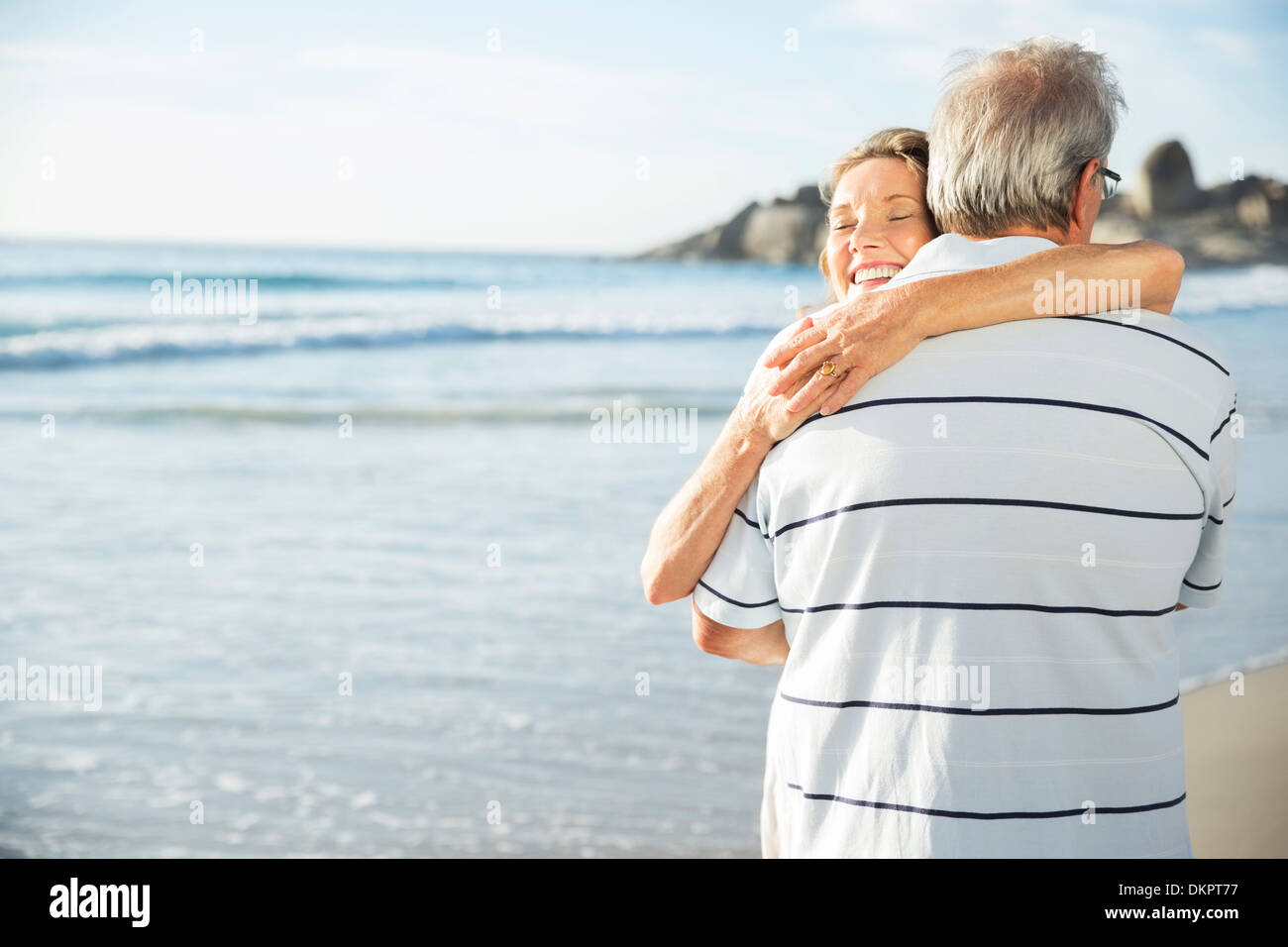 Senior couple hugging on beach Stock Photo