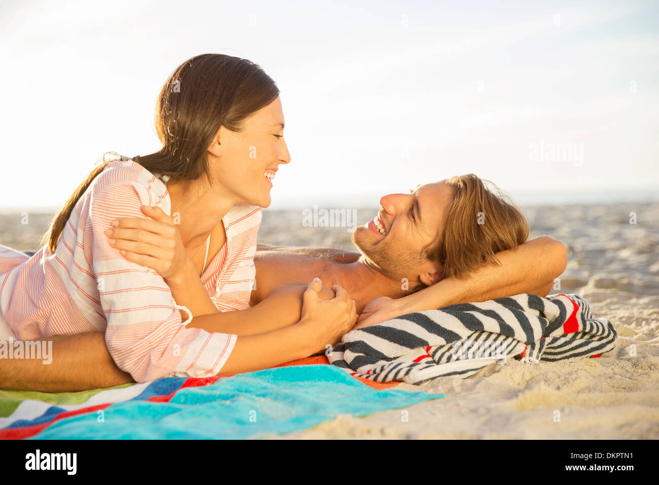 Couple relaxing together on beach Stock Photo