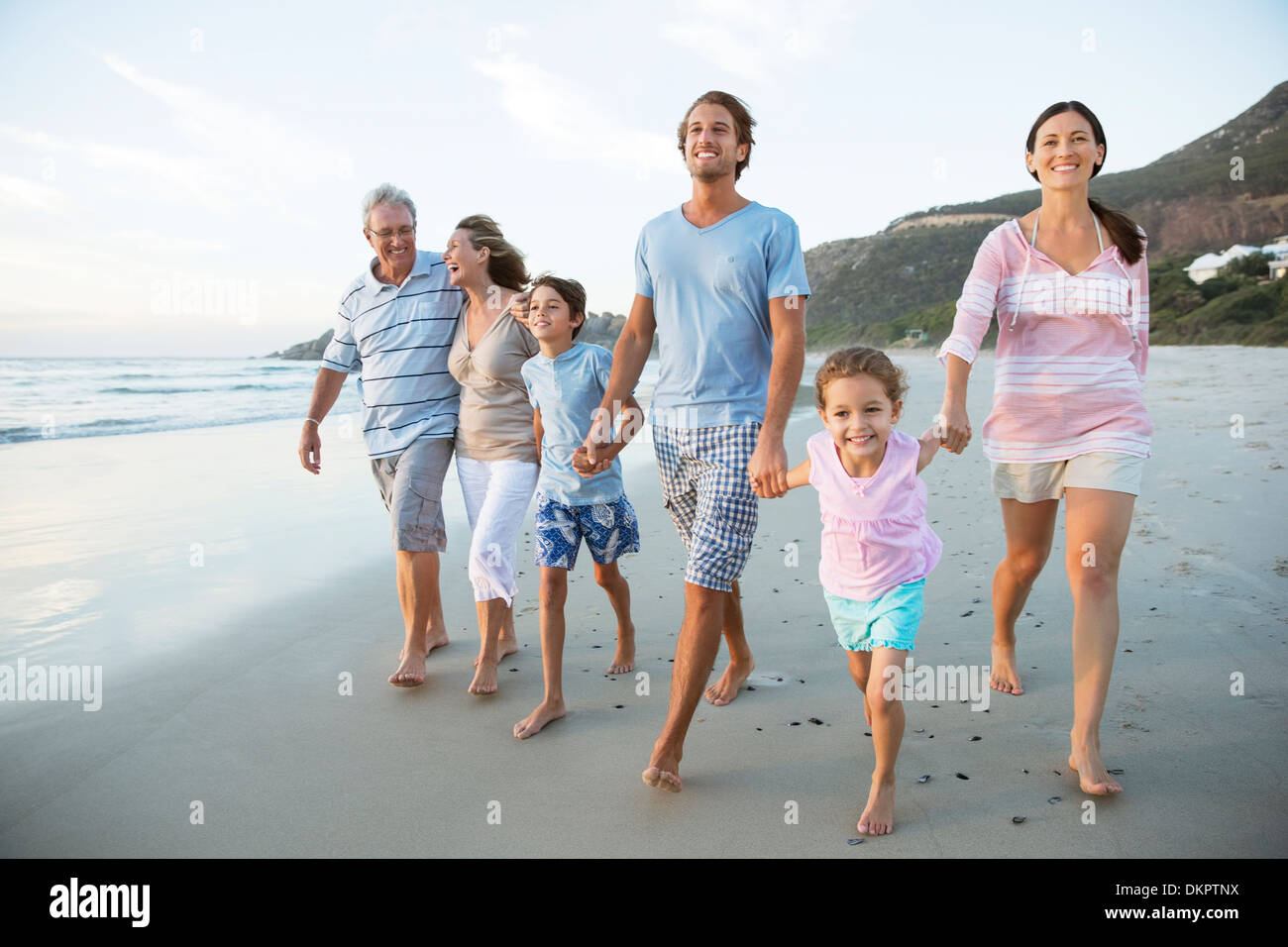 Family walking together on beach Stock Photo