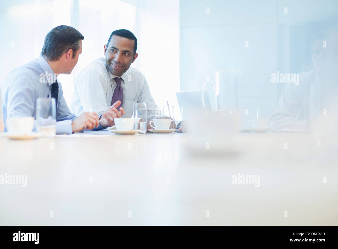 Businessmen talking in conference room Stock Photo