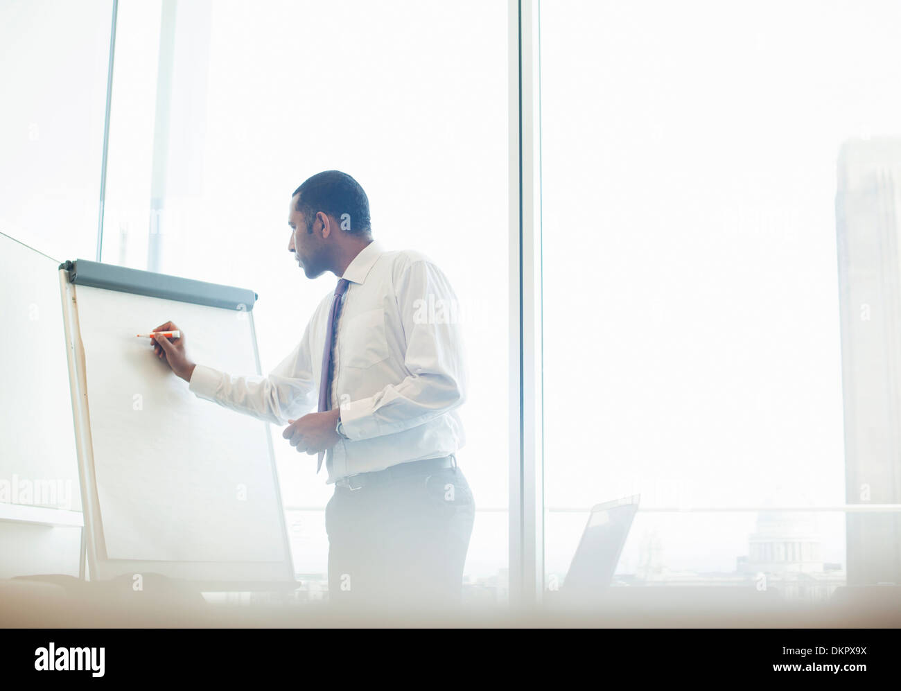 Businessman writing on whiteboard Stock Photo