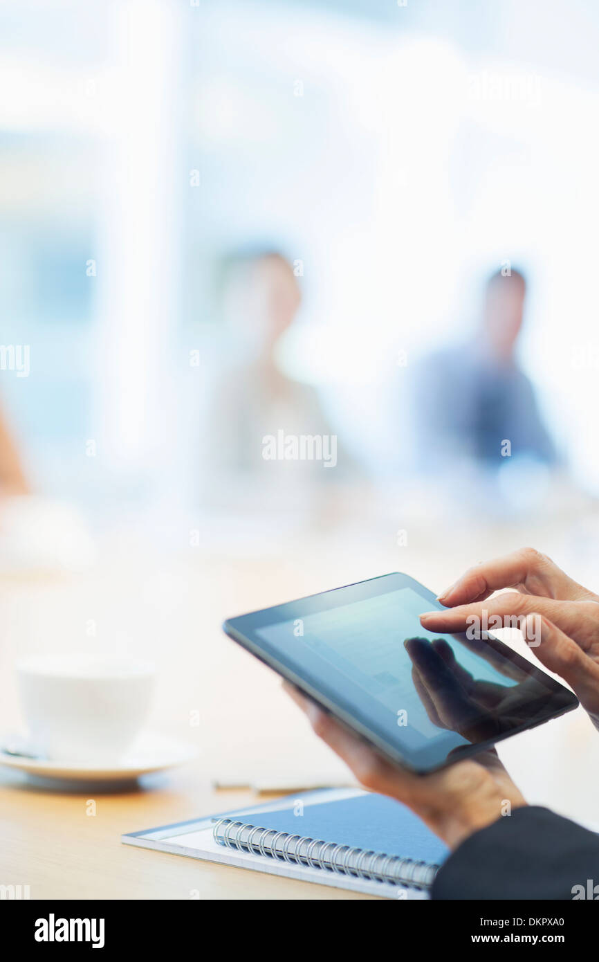 Businessman using digital tablet in meeting Stock Photo