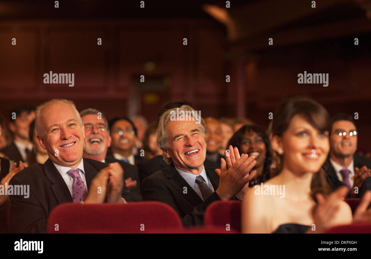 Theater audience laughing and clapping Stock Photo