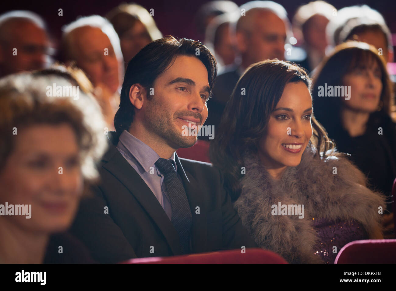Close up of smiling couple in theater audience Stock Photo