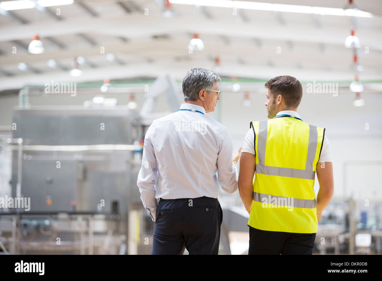 Workers talking in warehouse Stock Photo