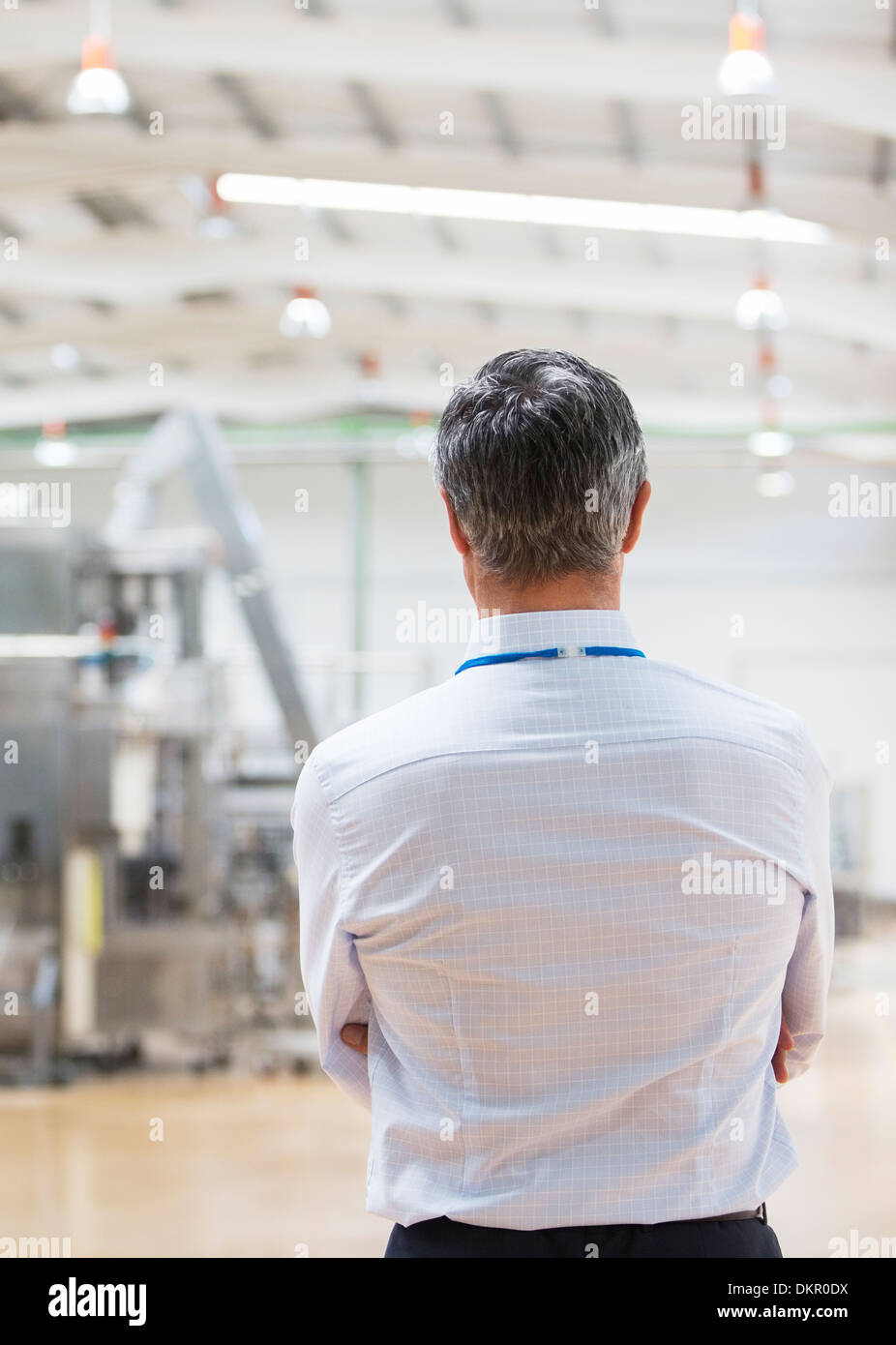 Businessman standing in factory Stock Photo