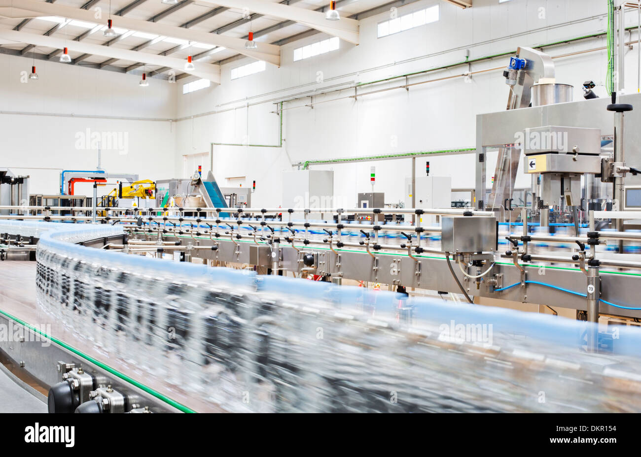 Bottles on conveyor belt in factory Stock Photo