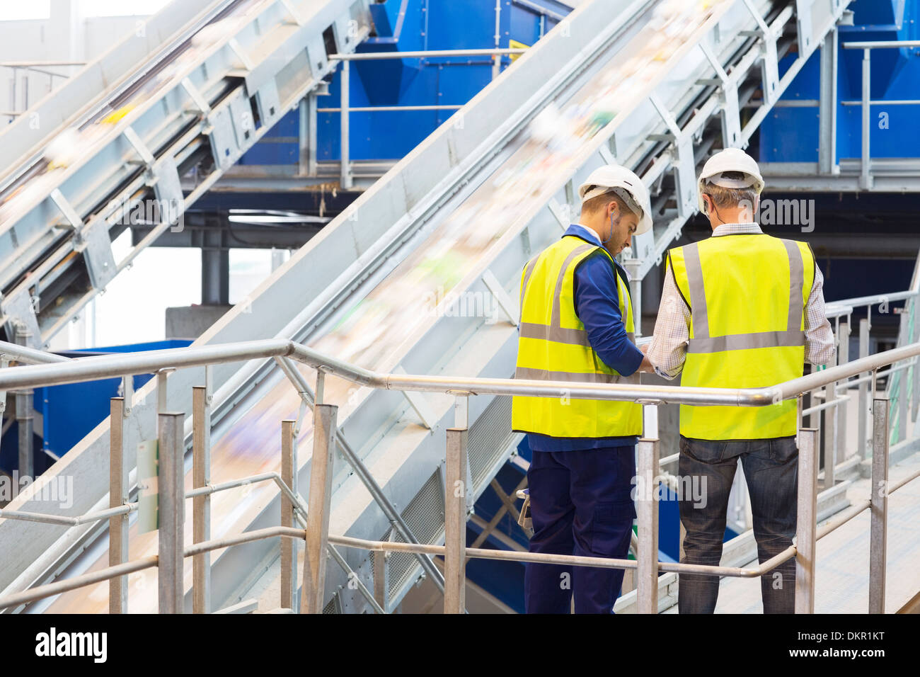 Workers talking in recycling center Stock Photo