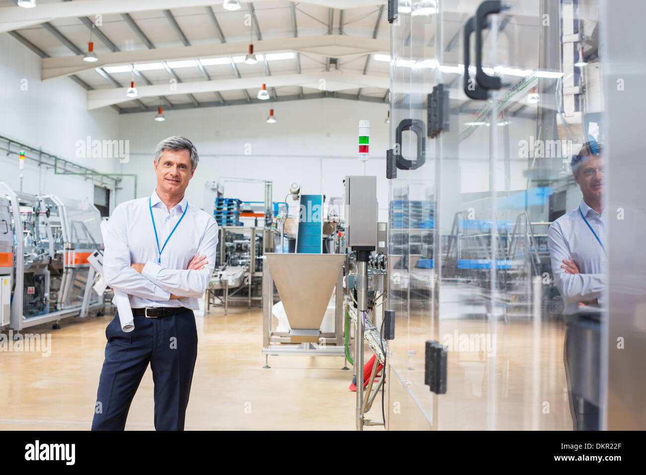 Businessman smiling in factory Stock Photo