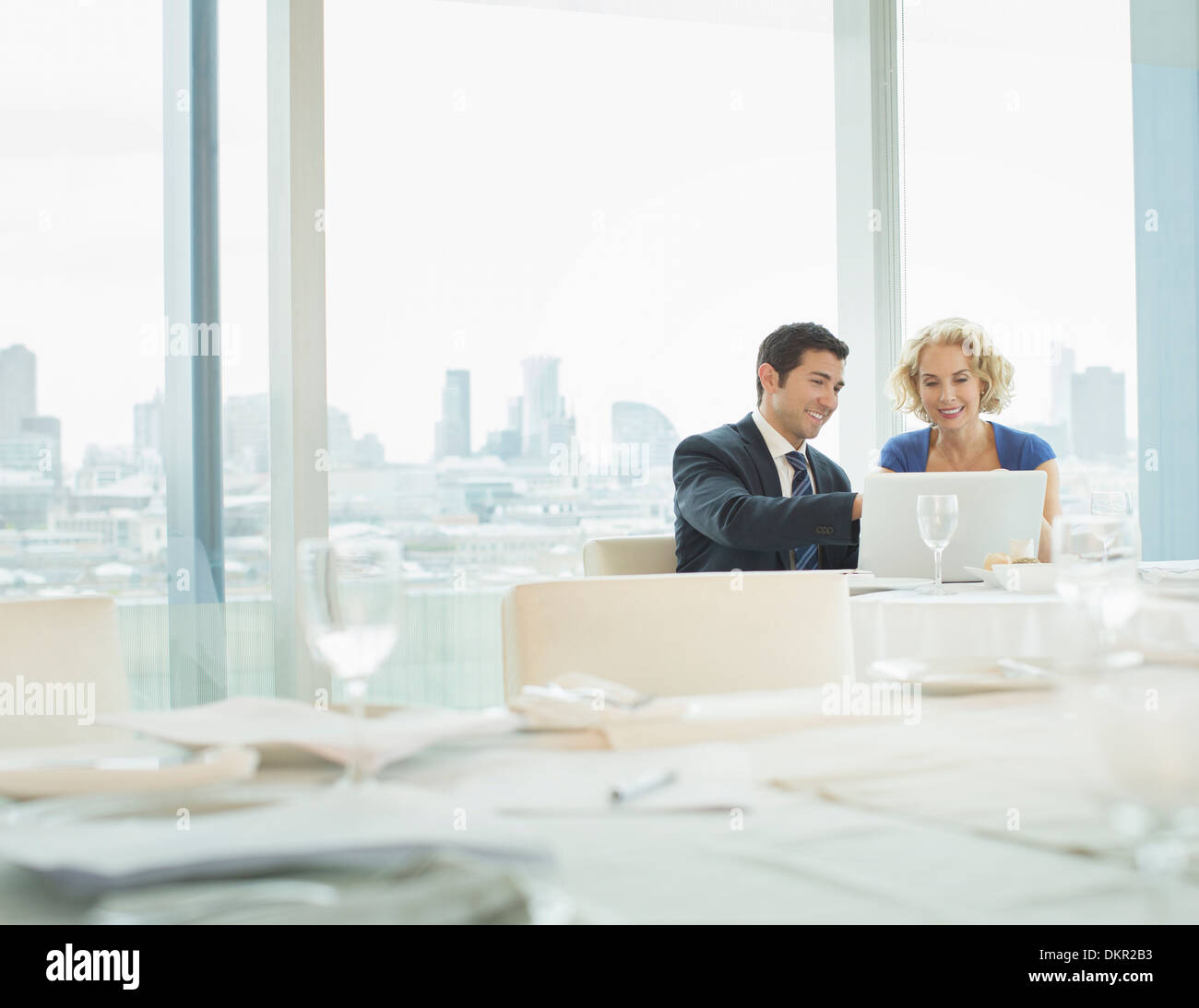 Business people using laptop in restaurant Stock Photo