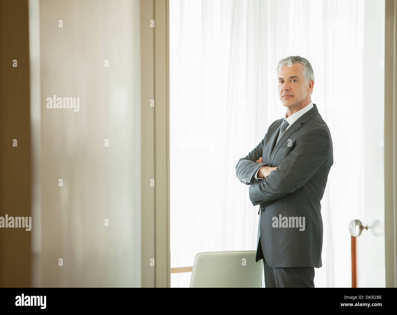 Businessman standing in doorway Stock Photo