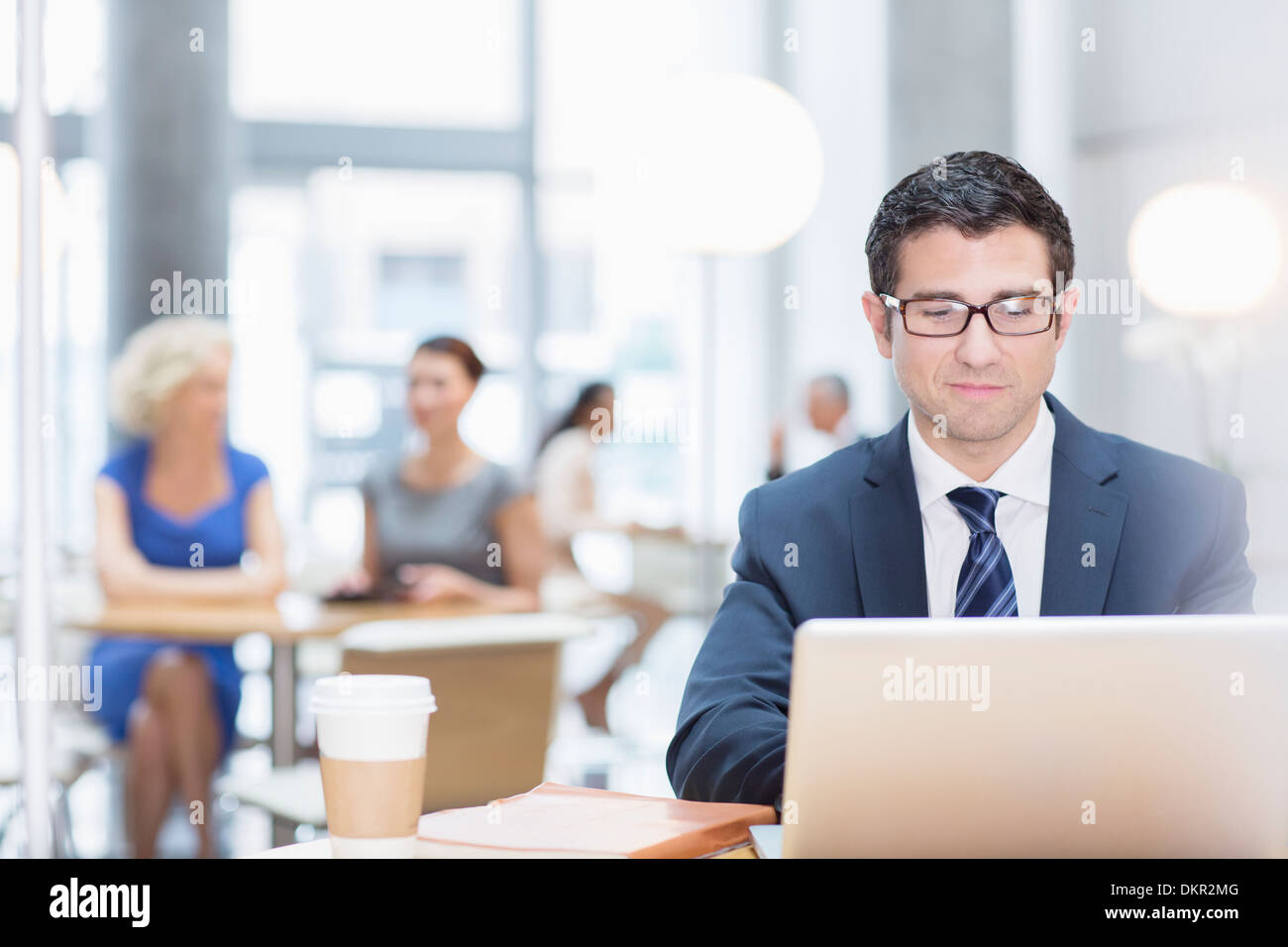 Businessman working at laptop in cafe Stock Photo