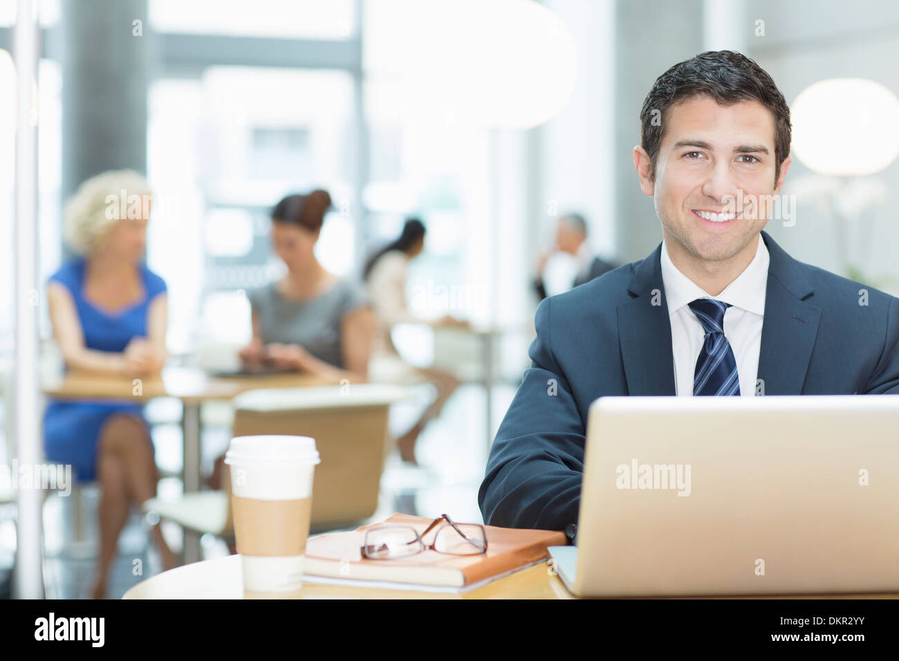Businessman using laptop in cafe Stock Photo