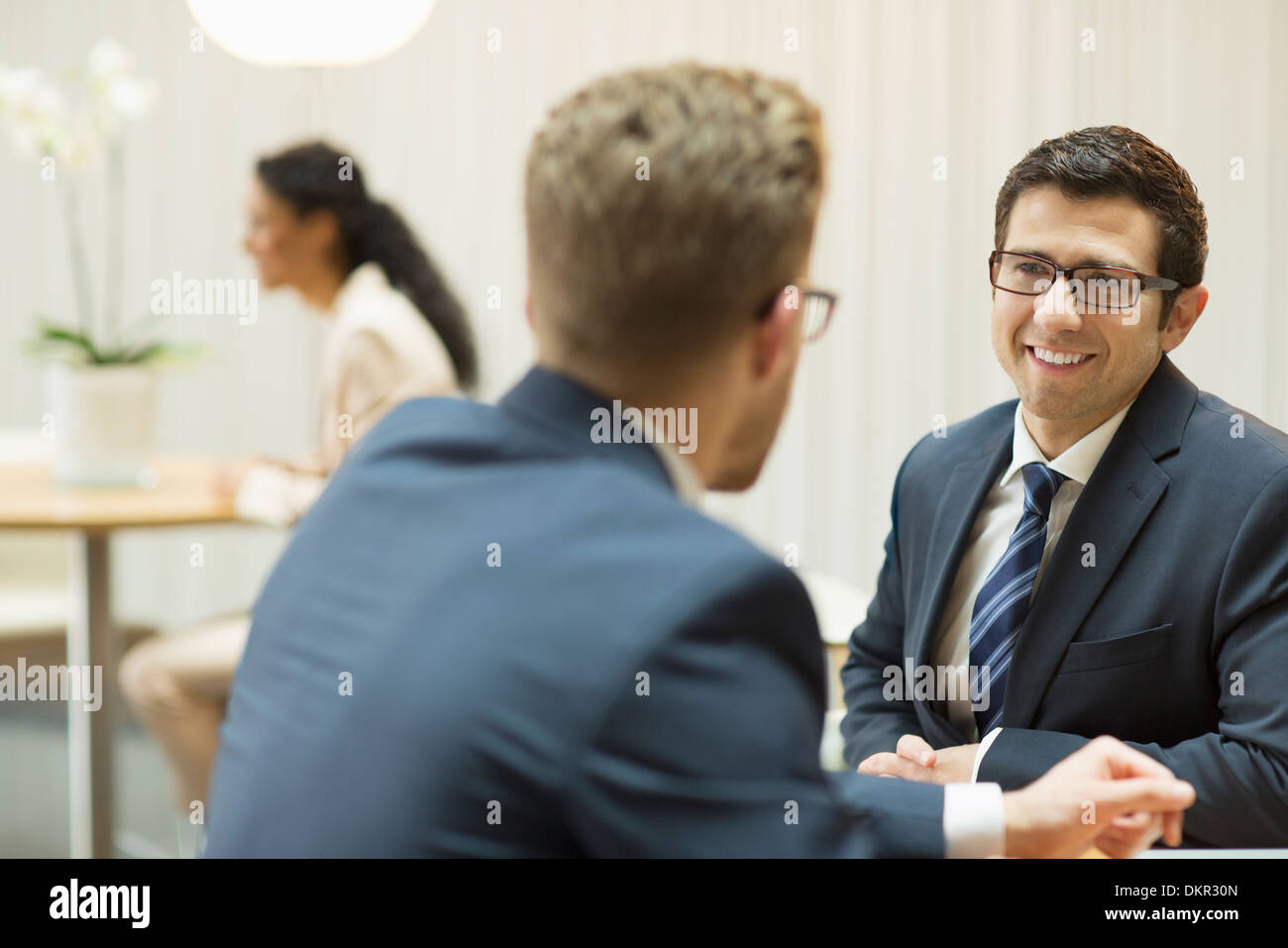 Businessmen talking in office Stock Photo