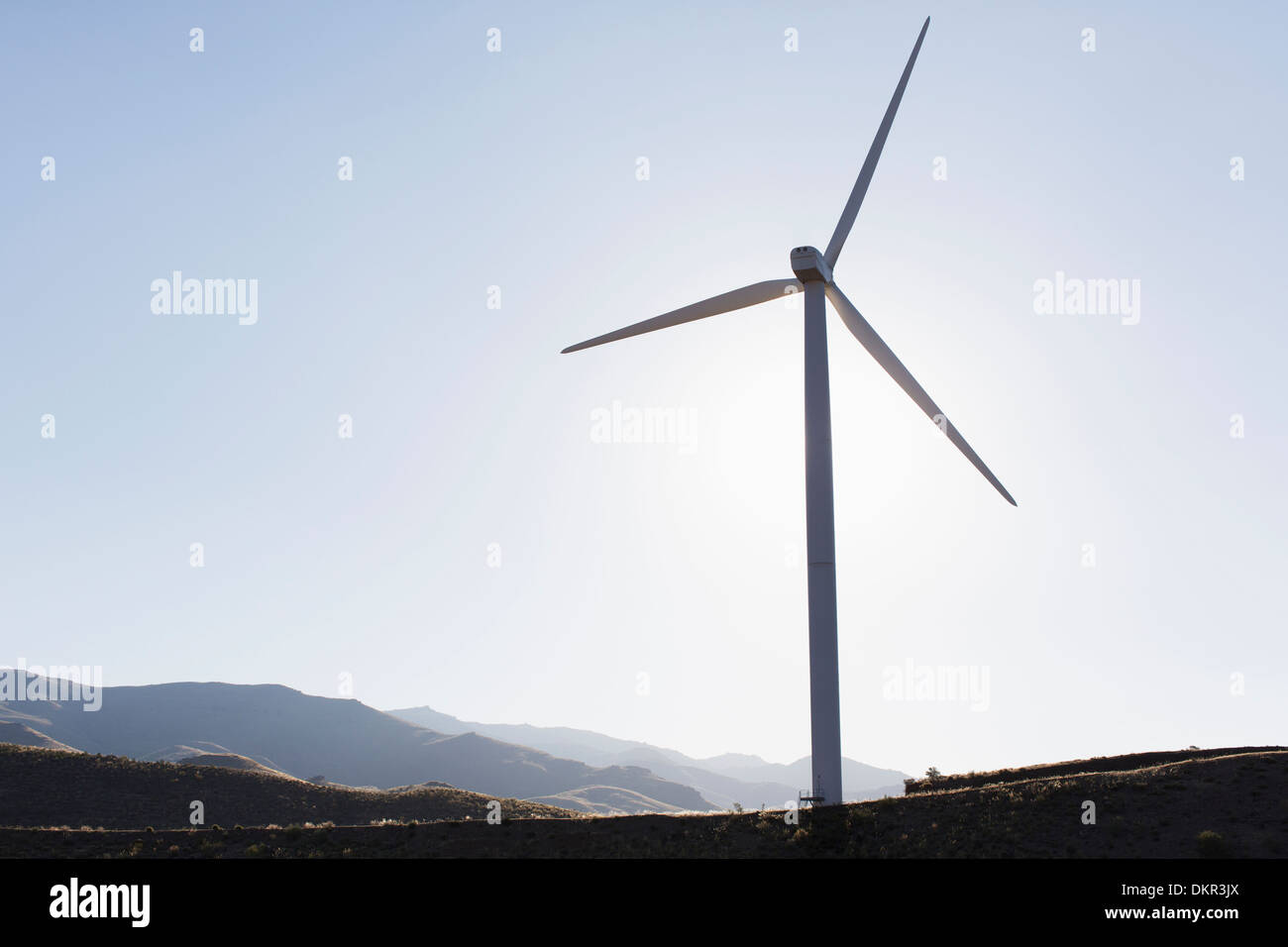 Silhouette of wind turbine in rural landscape Stock Photo