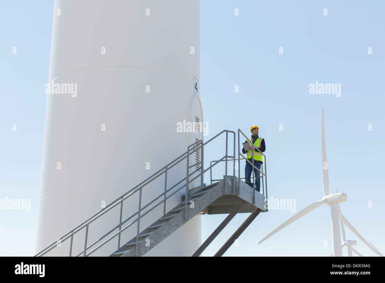 Worker standing on wind turbine Stock Photo