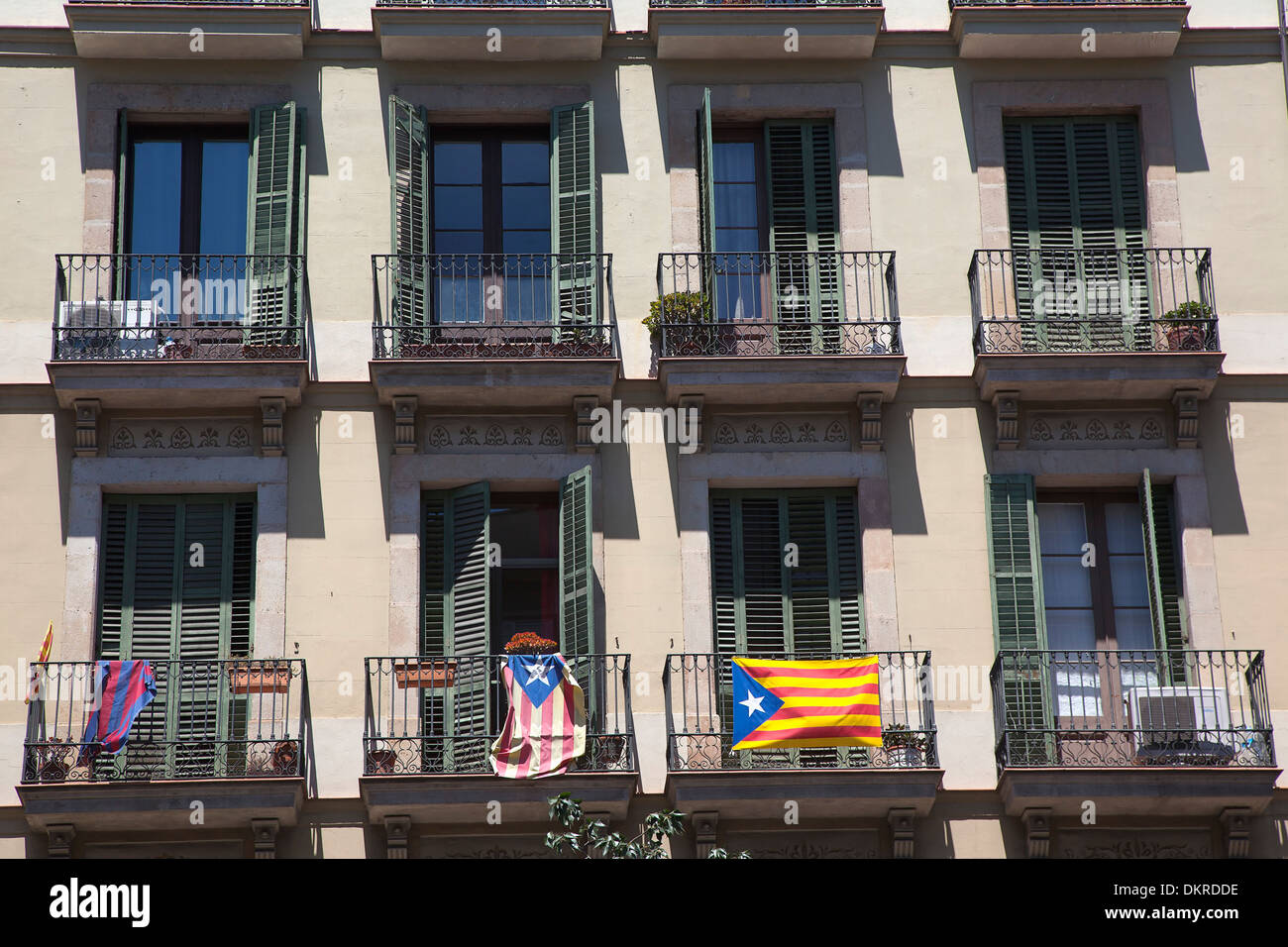Spain, Catalonia, Barcelona, Eixample, Typical apartment building facade with balconies, flying Catalan independence flags. Stock Photo