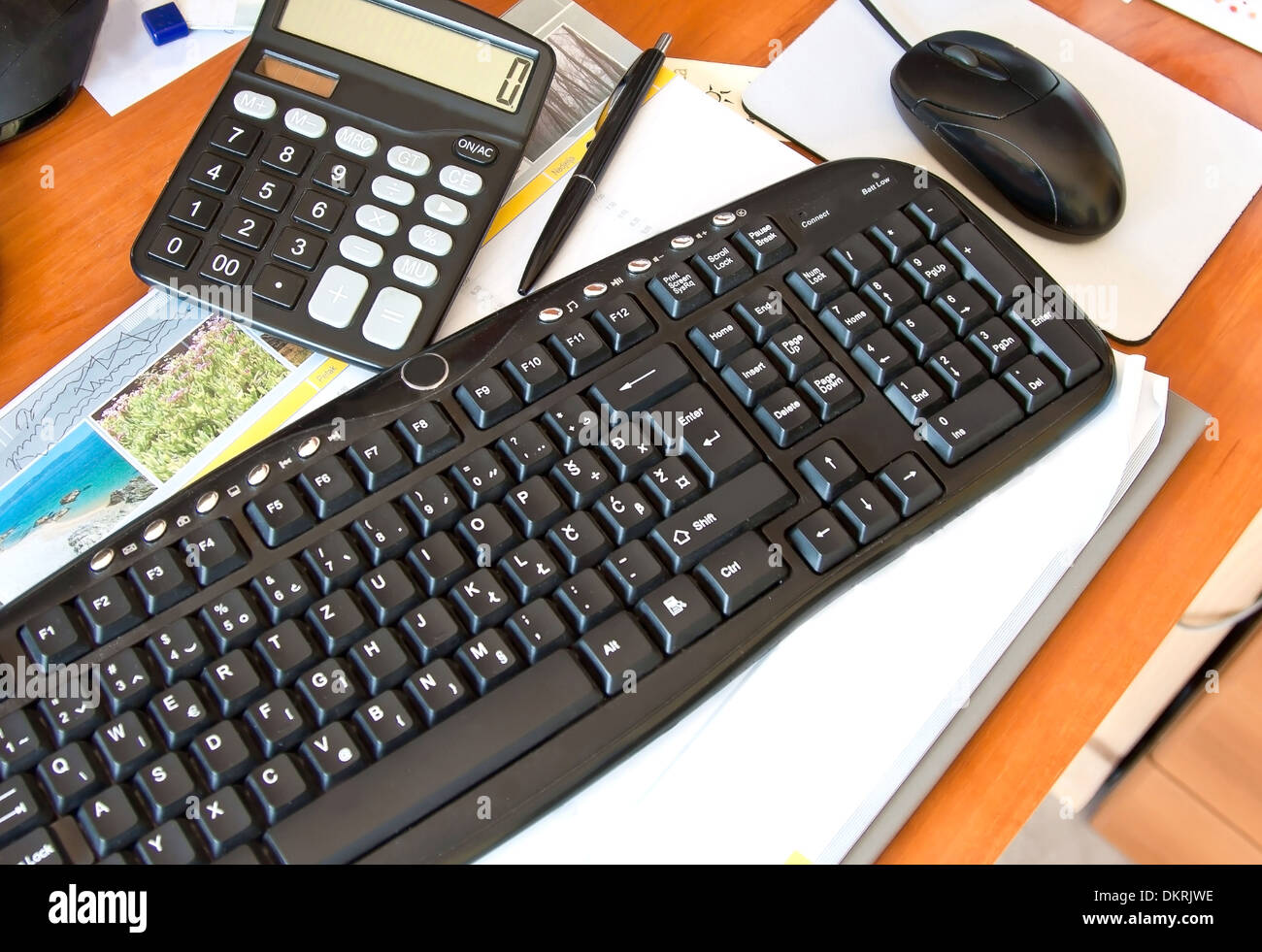 office desk with keyboard, calculator, mouse and pen Stock Photo Alamy