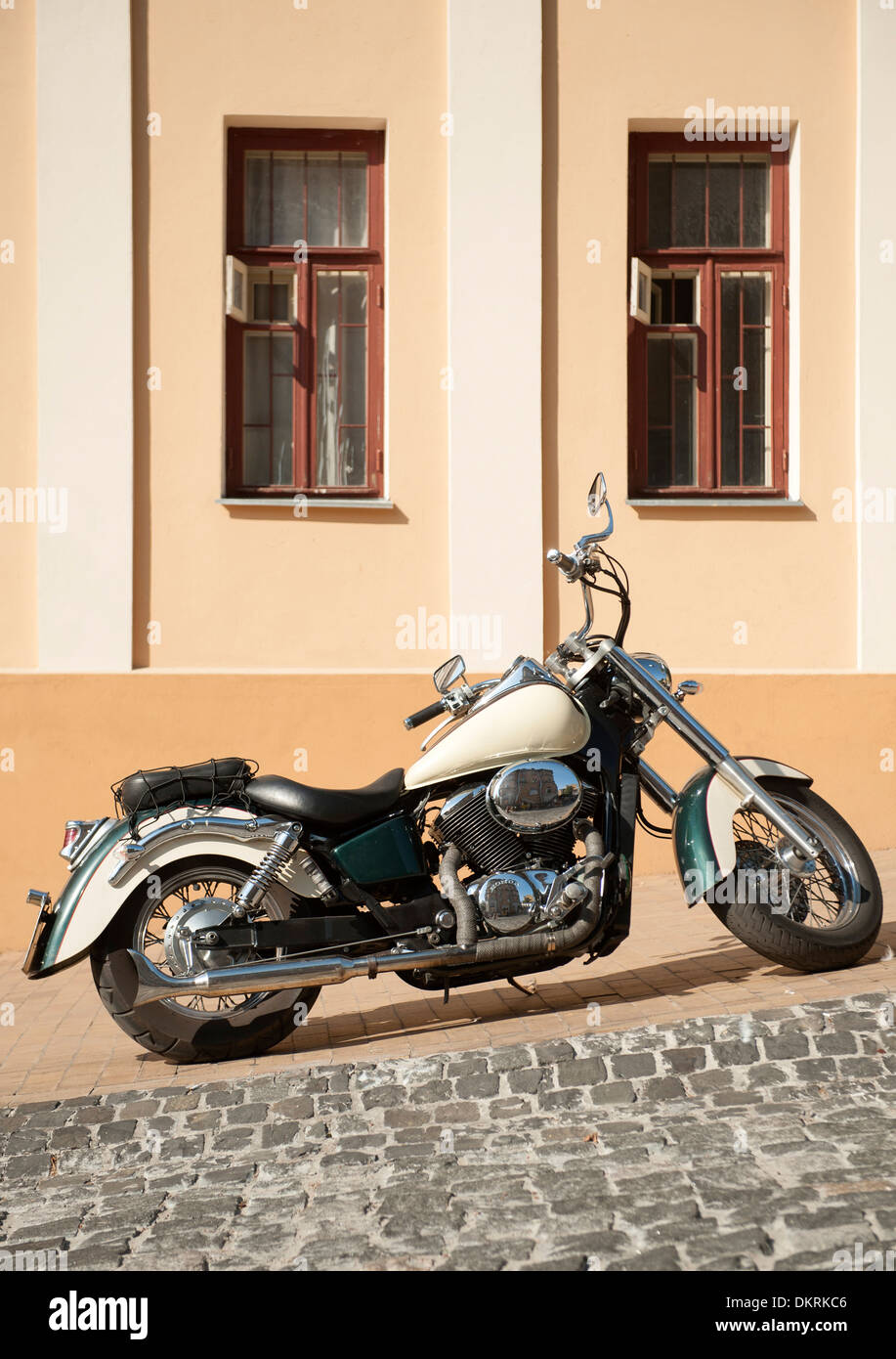 Vintage style motorcycle parked on Andriyivskyy Descent, a famous road in Kiev, the capital of the Ukraine. Stock Photo