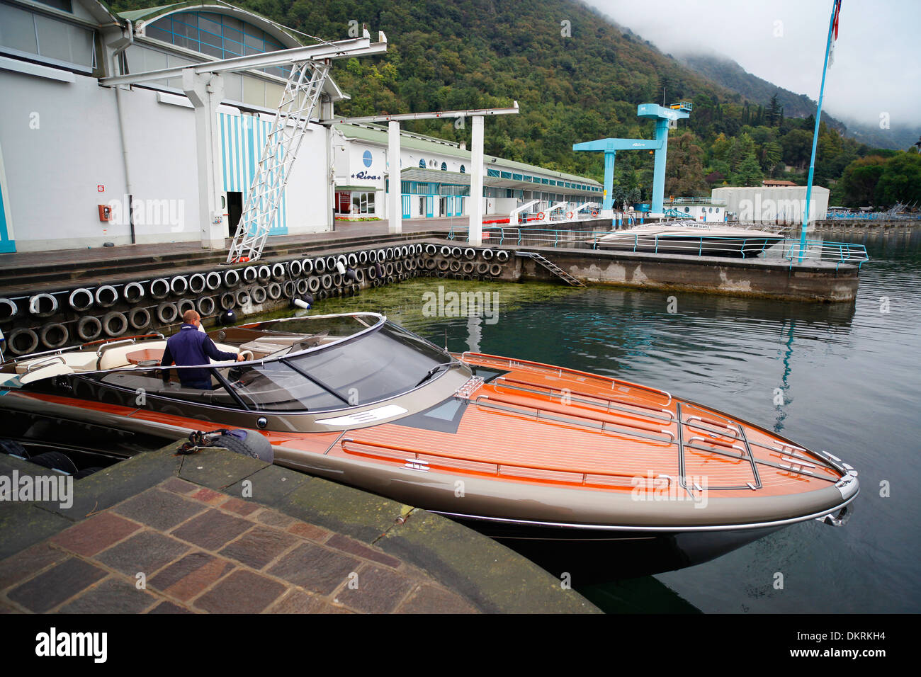 A Rivarama super yacht outside the Riva factory on a misty Lake Iseo in Sarnico, Italy. Stock Photo