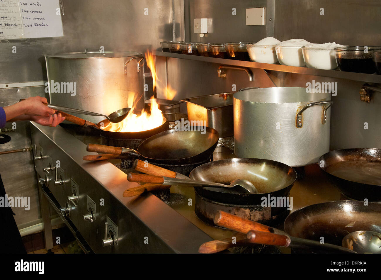 Chinese cooking with woks Stock Photo