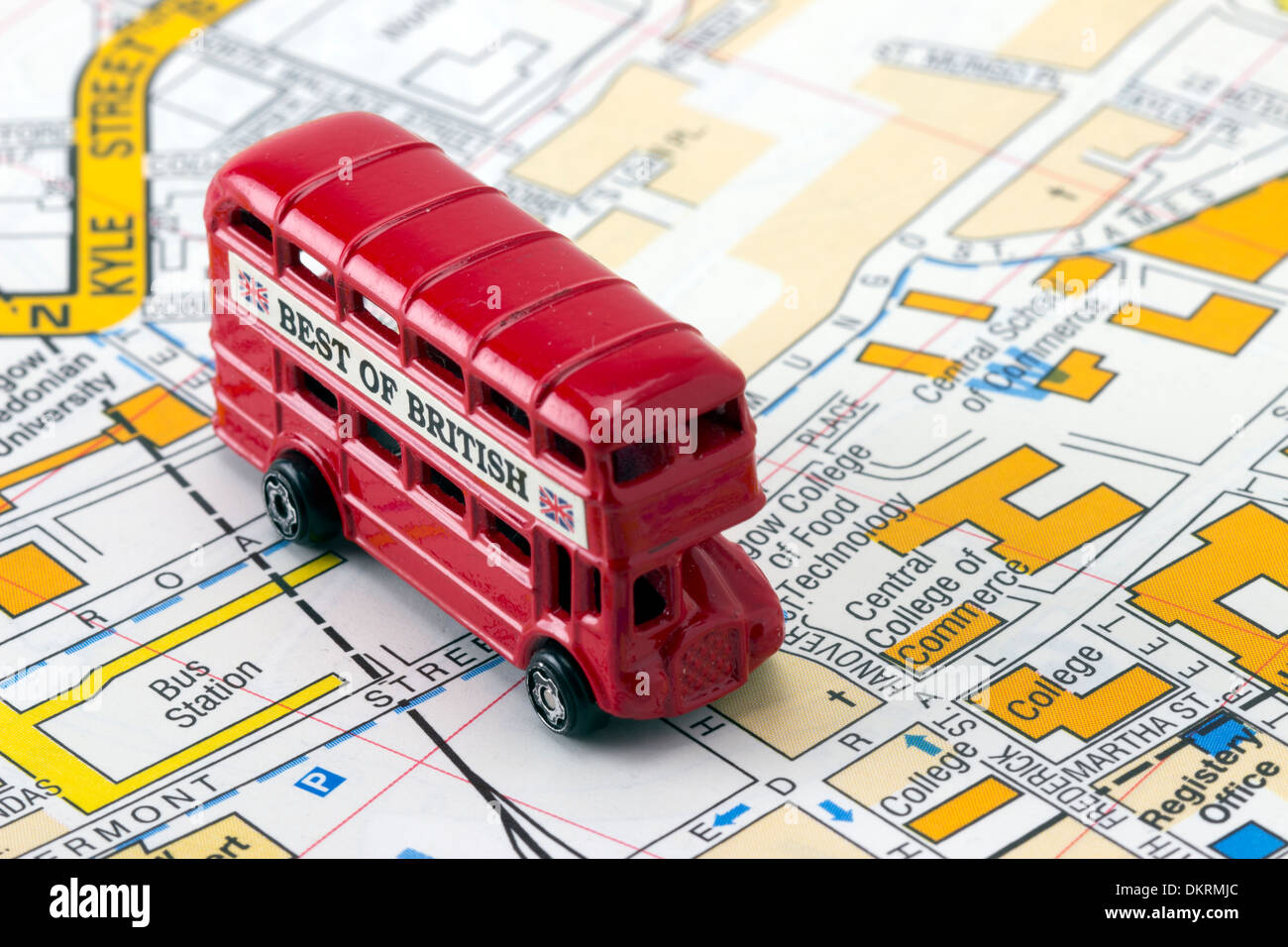Toy Red Bus on Map en route to Bus Station Stock Photo