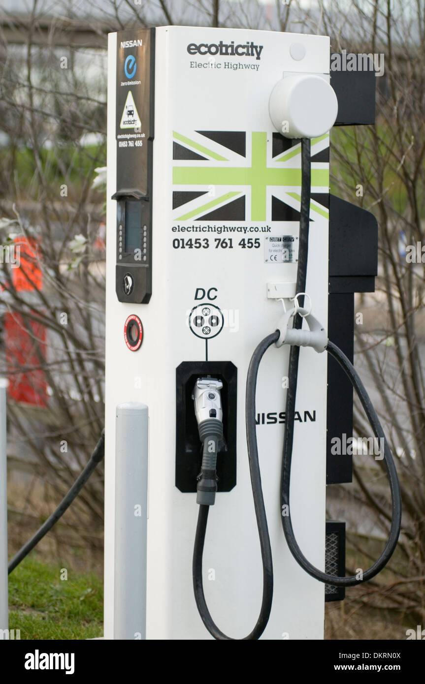 plug plugging in socket sockets recharge up batteries electrical cable cables battery nissan leaf at trowel motorway service sta Stock Photo
