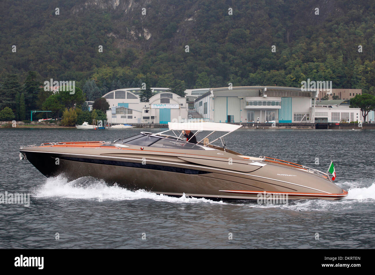 A Rivarama super yacht near the Riva factory on a misty Lake Iseo in Sarnico, Italy. Stock Photo
