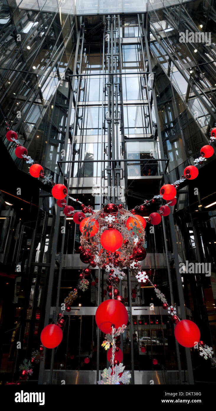 Red Christmas decorations at entrance to One New Change shopping mall in Central London UK   KATHY DEWITT Stock Photo