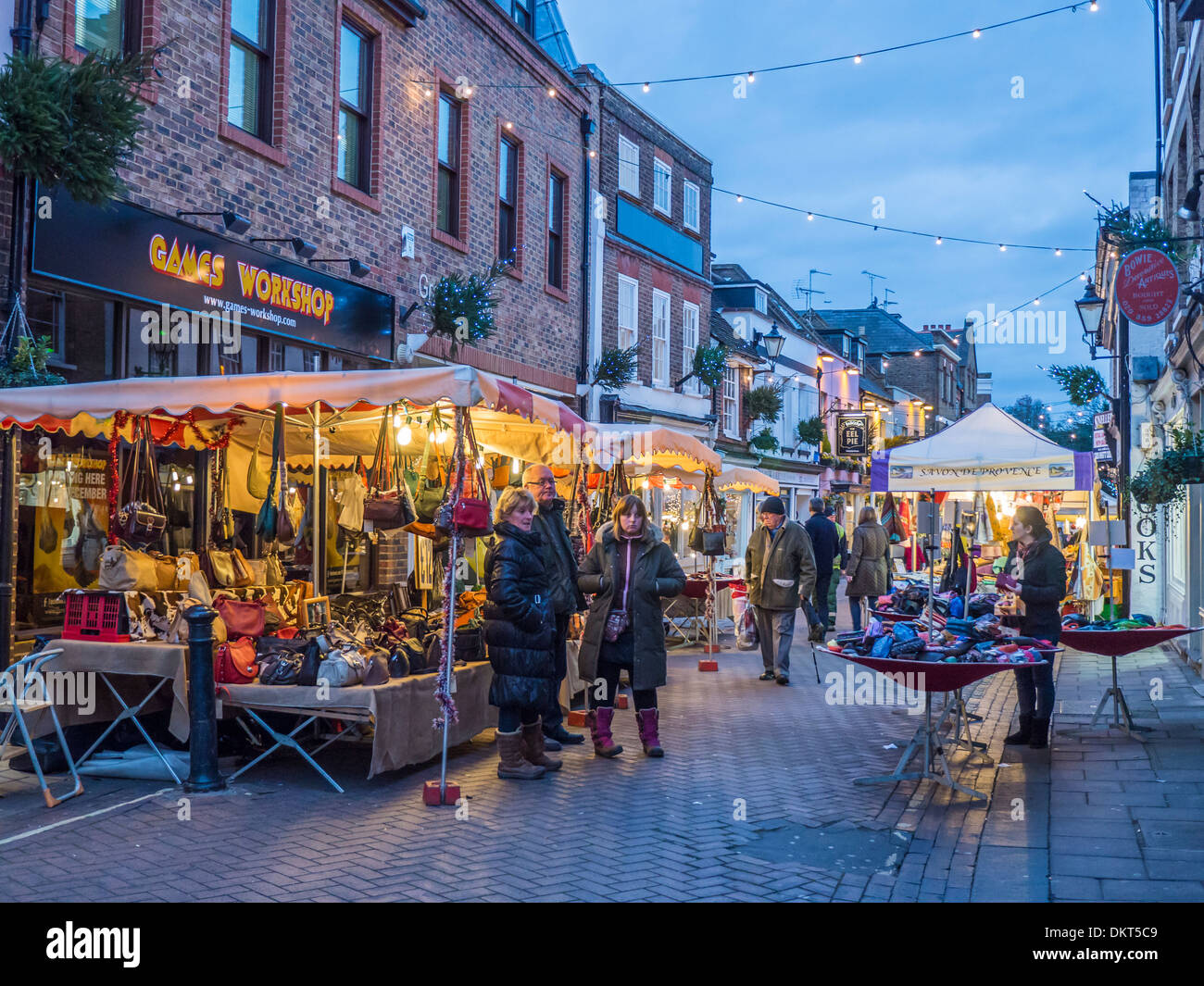 People walk past stalls of a Christmas French Market at dusk in Church  Street, Twickenham, Greater London Stock Photo - Alamy