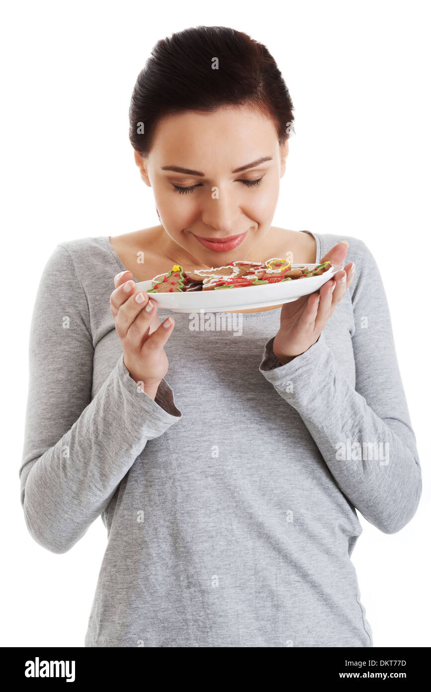 Beautiful young woman with cookies on a plate. Isolated on white Stock ...
