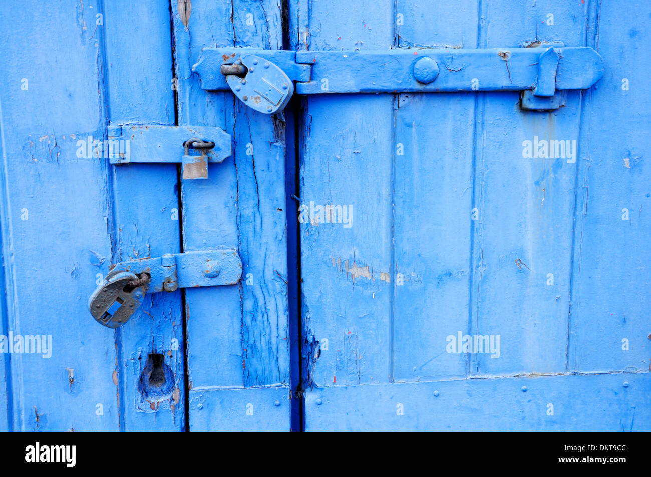 Maidstone, Kent , England. Three padlocks on a painted blue door Stock Photo