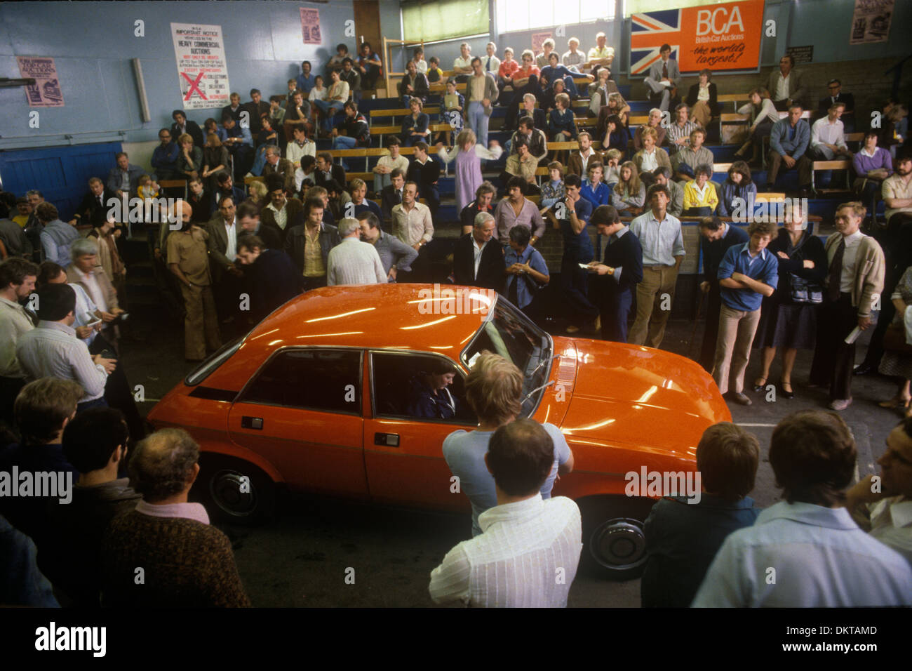 British Car Auctions secondhand car cars about to be auctioned. Buyers gather in order to watch or make a bid. Wandsworth Bridge Road, Fulham, London, England. 1981 1980s UK HOMER SYKES Stock Photo