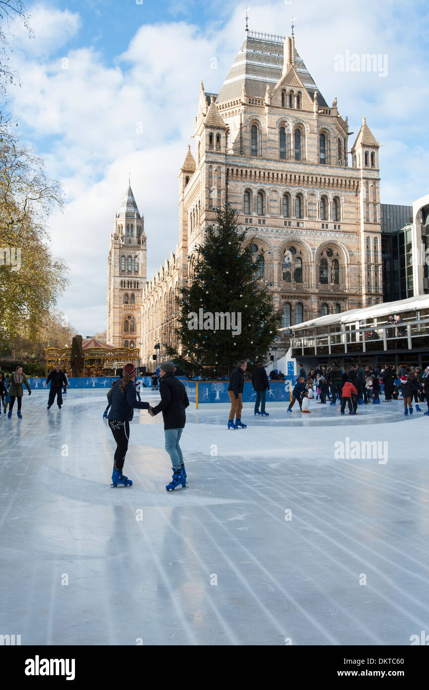 People skating on an ice rink created in the grounds of the Natural History Museum, London, England Stock Photo