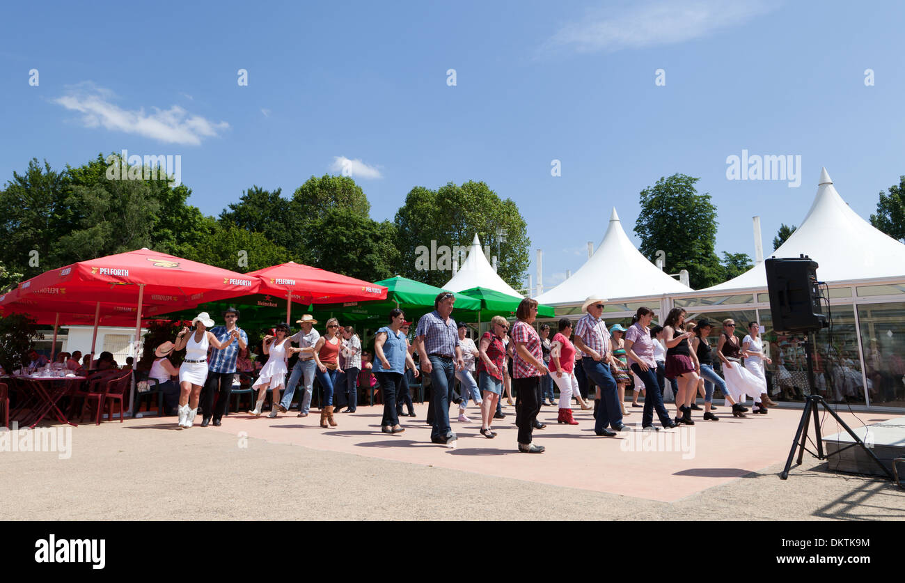 Montrichard, line dancers, line dancing to country music on a weekend in summer Stock Photo