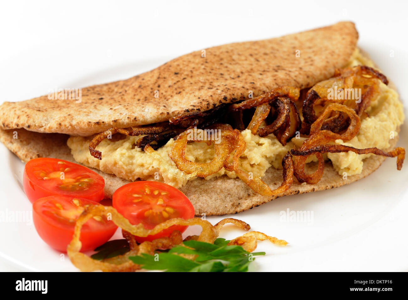 A pitta bread, or kubz, sandwich made with hummus and caramelised