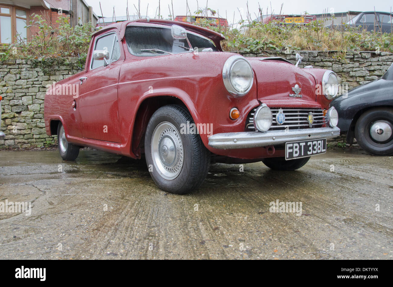 Red Classic pick up truck based on Austin A50 Car.  Rainy day Stock Photo