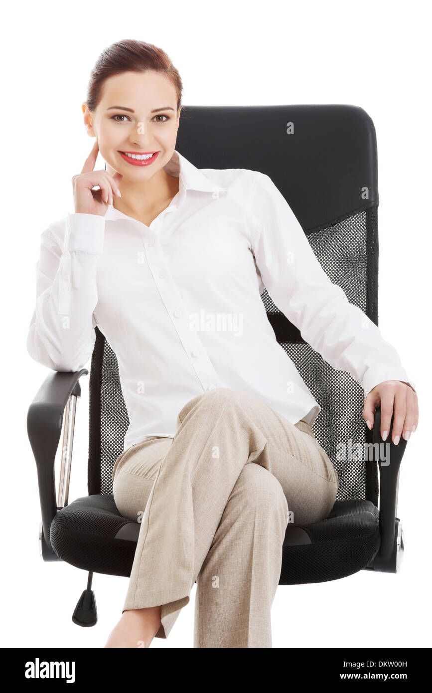 Beautiful business woman, boss sitting on a chair. Isolated on white.  Stock Photo