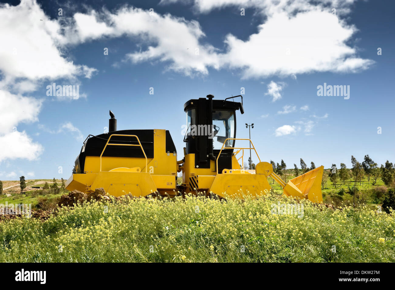 Heavy machinery in a green field Stock Photo