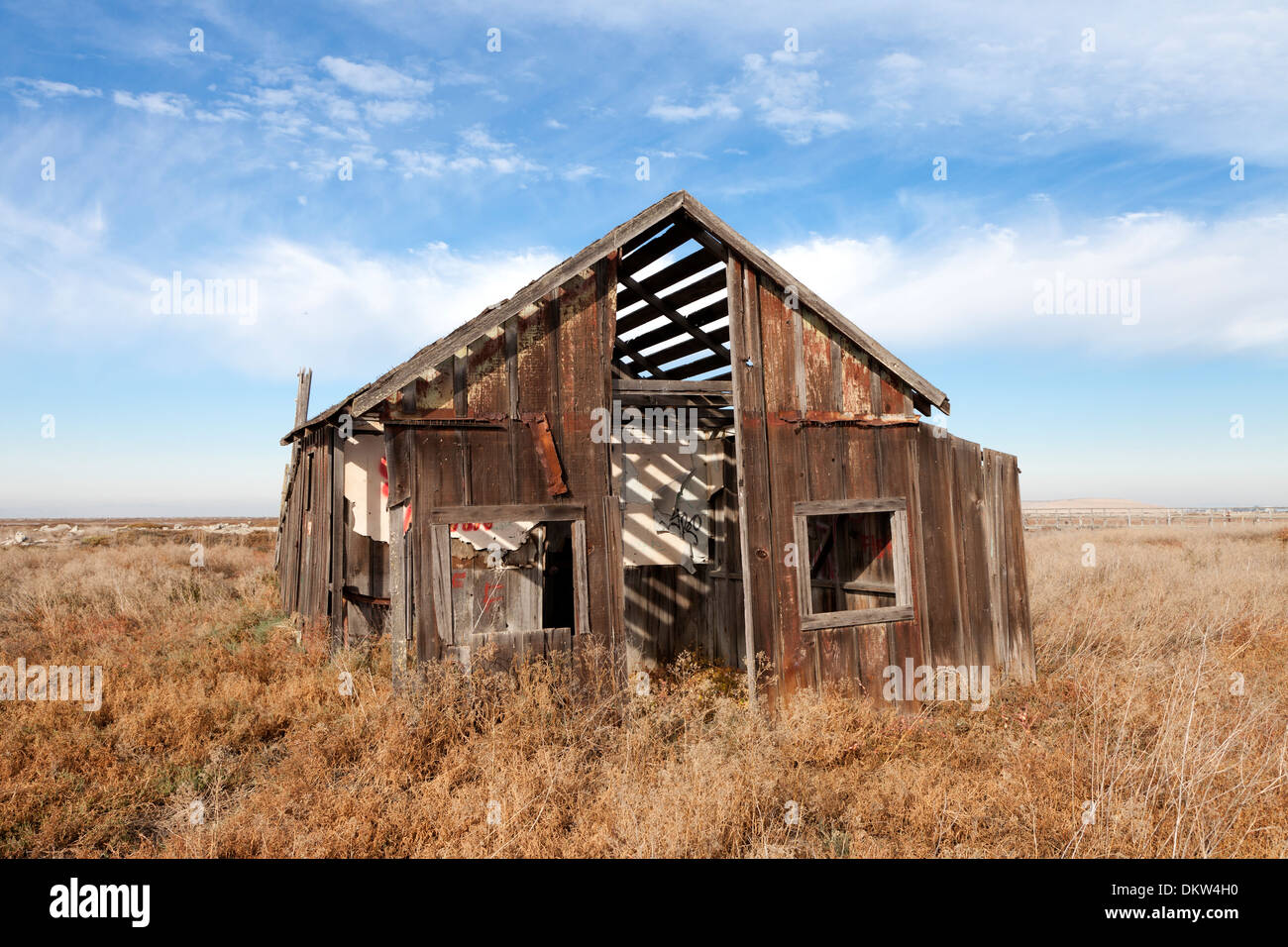 An abandoned shack slowly sinks into the marsh at the ghost town of Drawbridge in southern San Francisco Bay. Stock Photo