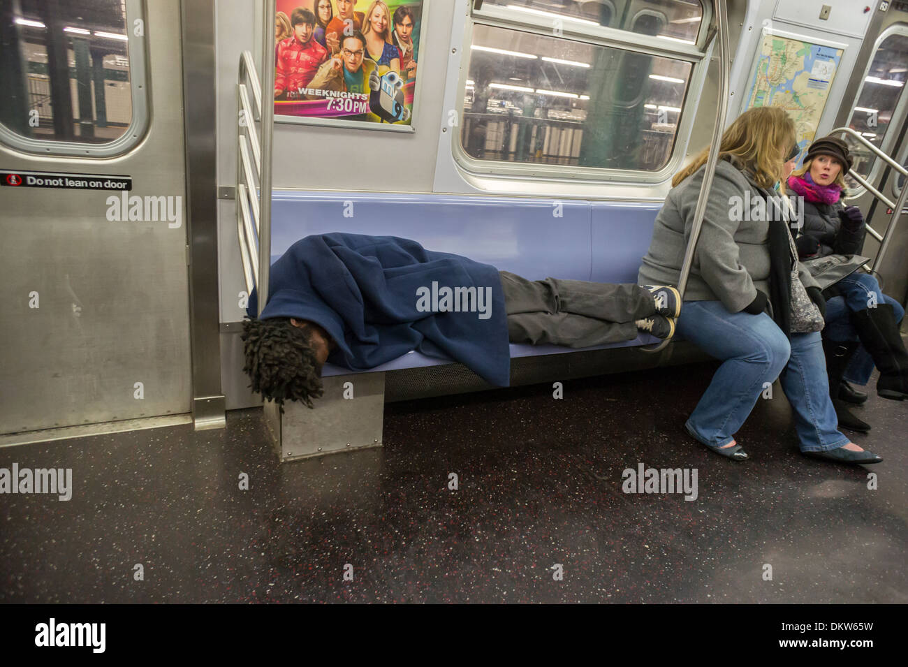 Homeless man takes up several seats as he sleeps in a subway car in New ...
