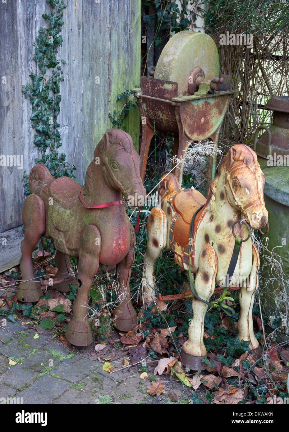 Old rusty metal rocking horses and grindstone Stock Photo Alamy