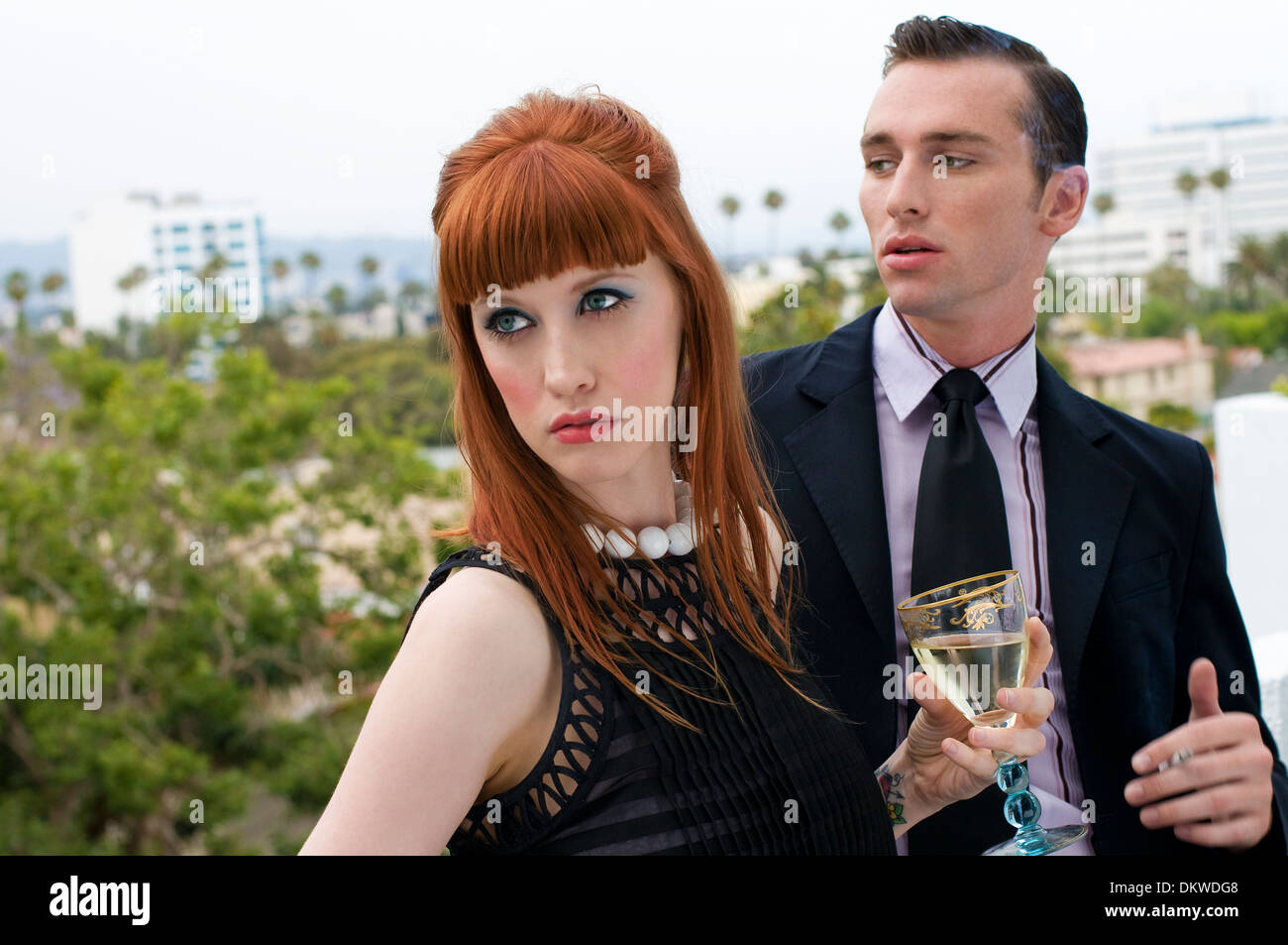 Young couple drinking and smoking in front Los Angeles background Stock Photo